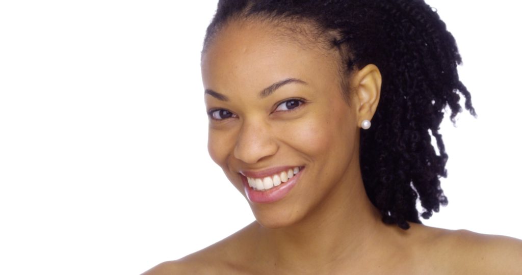 A smiling Black woman with great skin