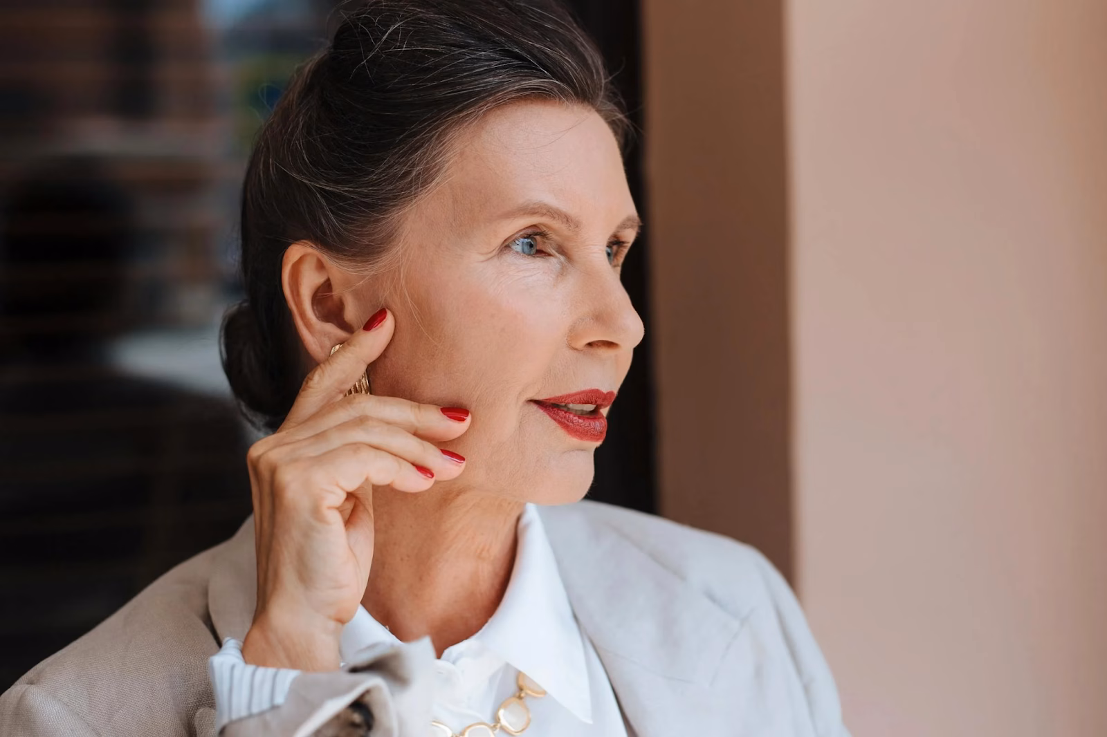 older woman with red fingernails